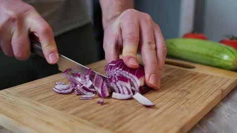 Cutting an onion on a chopping board. Stock Footage 305581785