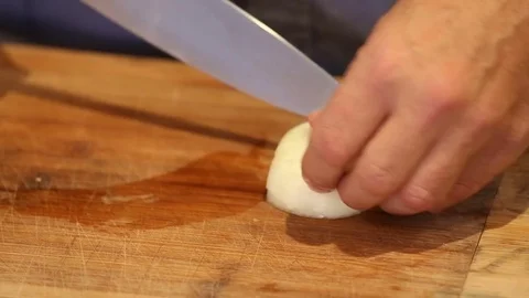 Cutting an Onion Close Up on Cutting Board Stock Footage 81276926