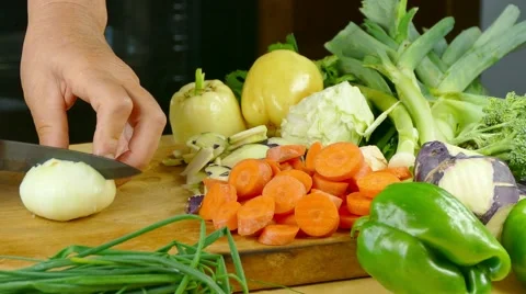 Cutting onion on desk in the kitchen - pan left Stock Footage 68064899