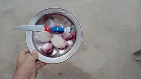 Cutting Onion with a Kitchen Knife on a Cutting Bowl Video stock 347424748