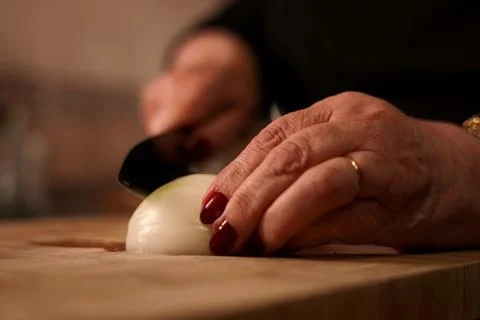 Cutting onion with knife. Stock Photos