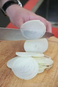 Cutting onion in thin slices Stock Photos
