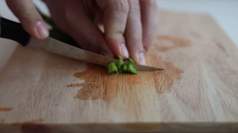 Cutting onions on a kitchen board Stock Footage 127703577