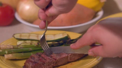 Cutting open a Medium Well Done Steak Stock Footage 97930688