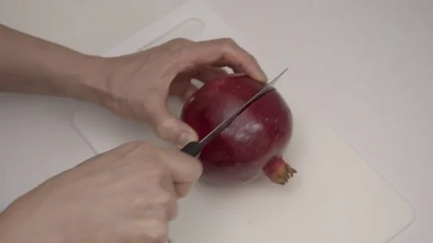 Cutting open a Pomegranate Fruit.  4K UHD. Video stock 69707672
