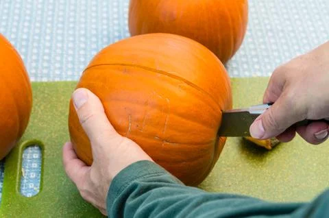 Cutting open a pumpkin in the kitchen Stock-Fotos