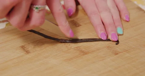 Cutting open vanilla bean stem with knife Stock Footage 249367920