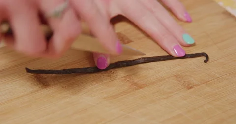 Cutting open vanilla bean stem with knife closeup Stock Footage 249368648