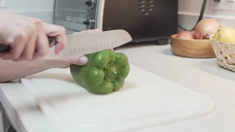 Cutting or Breaking Down a Bell Green Bell Pepper Stock Footage 106492920