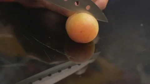 Cutting an orange apricot Stock Footage 62598042