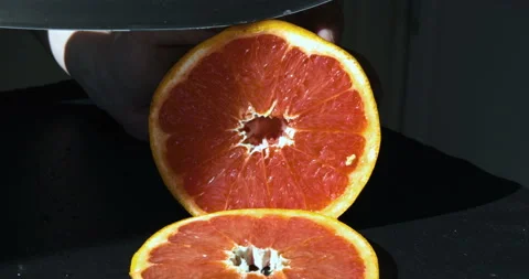 Cutting orange fruit for squeezing fresh juice Stock Footage 108134845