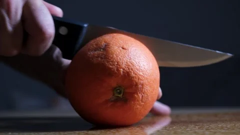 Cutting Orange in Half with Knife Close Up Stock Footage 329103272