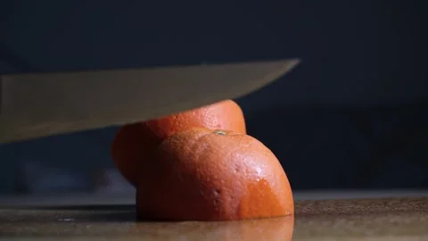 Cutting Orange in Half with Knife Close Up Stock Footage 329103282