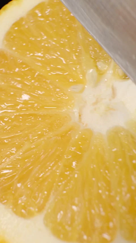 Cutting an Orange into Halves with a Knife Stock Footage 301522955