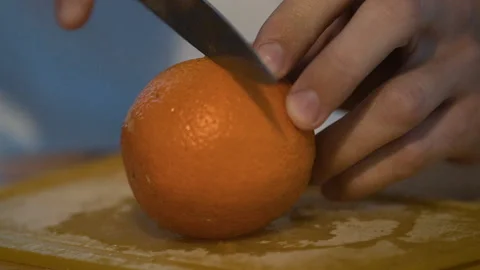 Cutting an orange with a knife Stock Footage 133169536