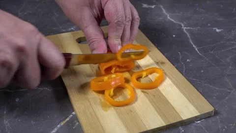 Cutting Of orange Paprika on the table Stock Footage 242362390