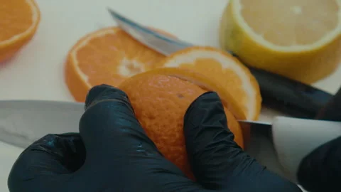 Cutting orange prep for drink Stock Footage 308464816