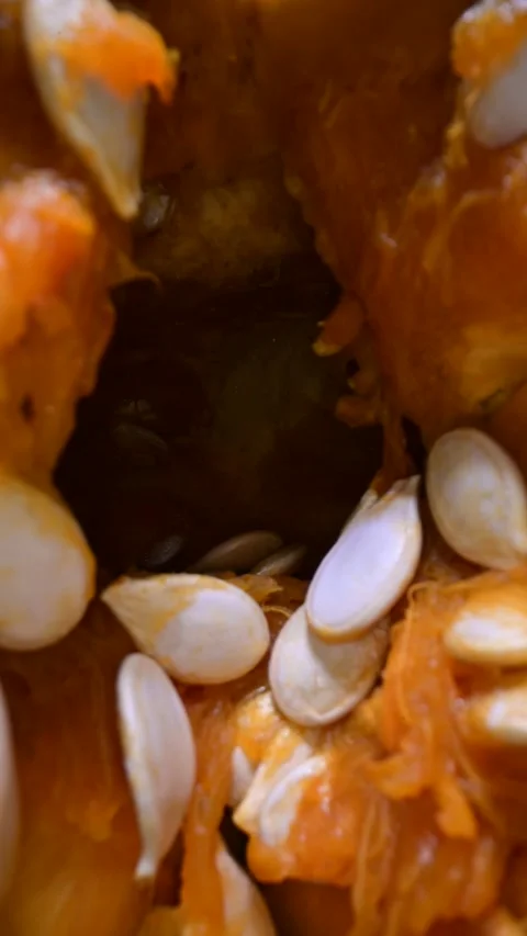 Cutting orange pumpkin with seeds close up Video stock 290389729