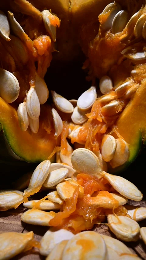 Cutting orange pumpkin with seeds close up Stock Footage 294615164