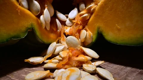 Cutting orange pumpkin with seeds close up Stock Footage 313081579