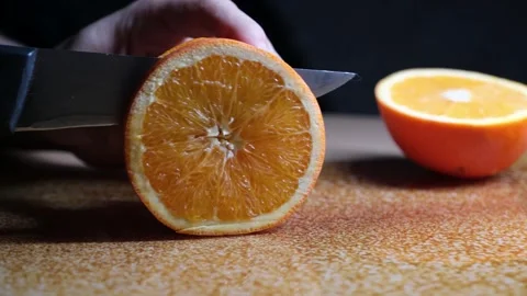 Cutting Orange into Slices on Kitchen Counter Stock Footage 329103373