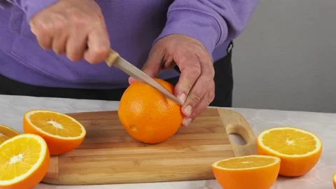 Cutting oranges in half Stock Footage 167010127