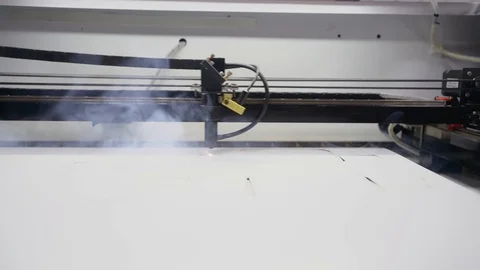 Cutting out cardboard packaging on a laser machine Stock Footage 129594950