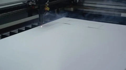 Cutting out cardboard packaging on a laser machine Stock Footage 129595330
