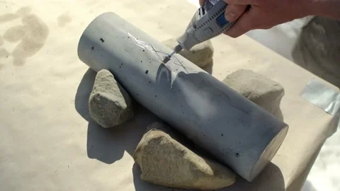 Cutting out shape in concrete with a rotating tool an a diamond cutting Stock Footage 223170160