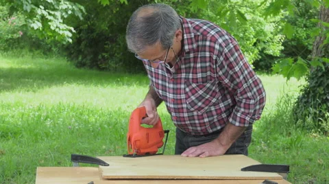 Cutting a panel with a jigsaw Video stock 63506304