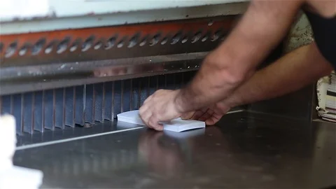 Cutting paper for making gift wrapping, leaflets and postcards. Stock Footage 124792742