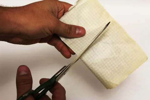 Cutting paper with scissors Stock Photos