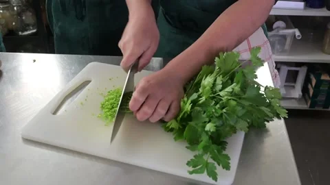 Cutting parsley with a knife in a kitchen Stock Footage 170606871
