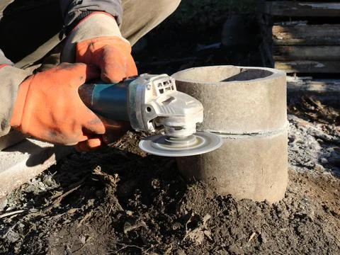 Cutting off part of the pipe with a grinder Stock Photos