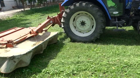 The cutting part of the tractor that cuts grass alfalfa in the garden Stock Footage 68321367