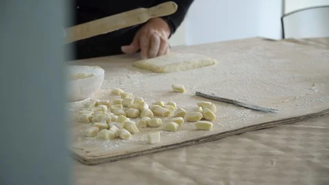 Cutting pasta gnocchi pan front view Stock Footage 128988000