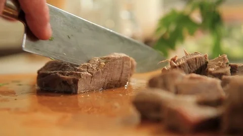 Cutting peace of boiled beef meat on a wooden cutting board Stock Footage