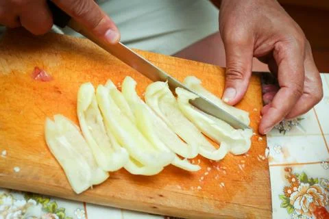 Cutting pepper on board Stock Photos