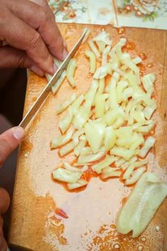 Cutting pepper on board Stock Photos