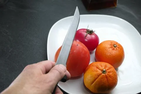 Cutting a persimmon Photos