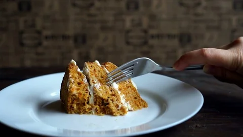 Cutting piece of carrot cake with fork. Man eating dessert cake. Slice of cake Stock Footage
