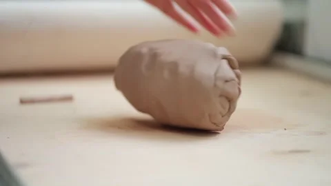 Cutting a piece of clay on a table with a string. Stock Footage 148984266