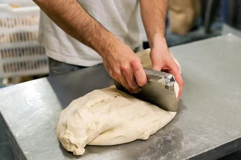 Cutting off piece of dough Stock Photos