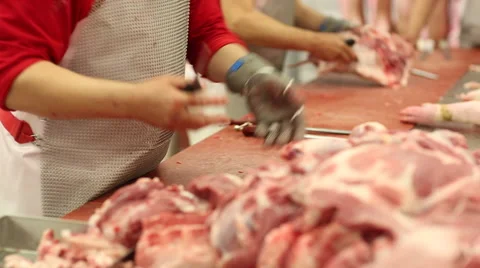 Cutting pig carcasses on a special table with knives Stock Footage 59869602
