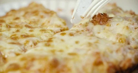 Cutting pizza with a fork and a disposable plastic knife Stock Footage 92161013