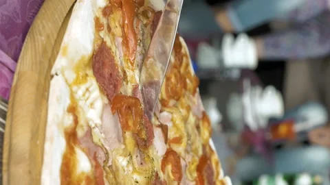 Cutting a pizza with the help of a fork and knife Stock Footage 91180914