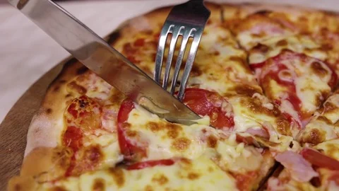 Cutting a pizza with a knife Stock Footage 82054045