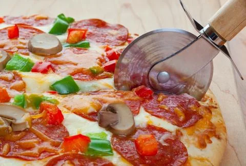 Cutting the pizza Stock Photos