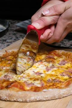 Cutting pizza Stock Photos