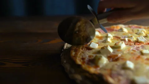Cutting pizza into pieces, close-up Stock Footage 87870396